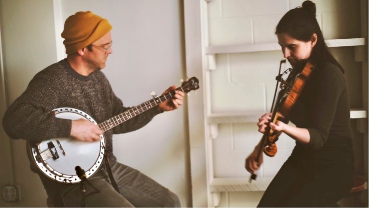 Joseph playing banjo, Stephanie playing fiddle